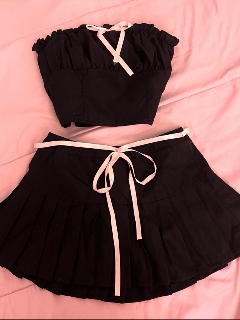 Chic Black Two-Piece Crop Top & Pleated Skirt with pink Ribbon
